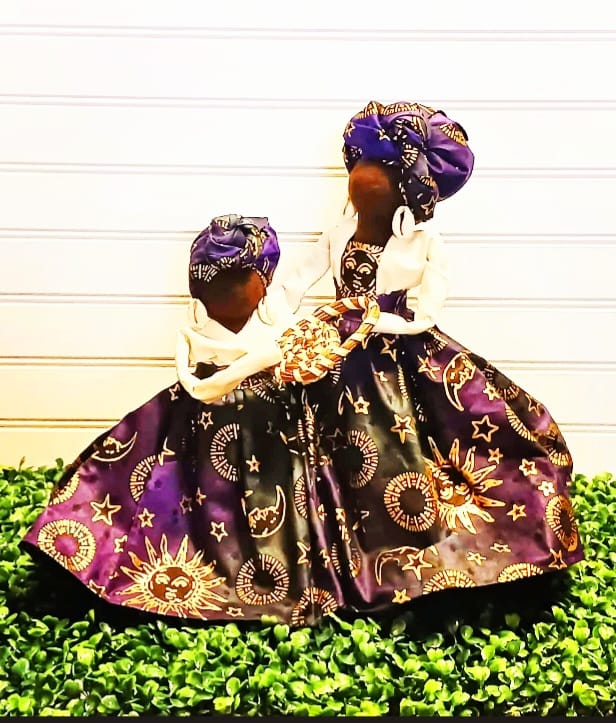 two handmade Gullah Dolls sharing sweet grass basket weaving